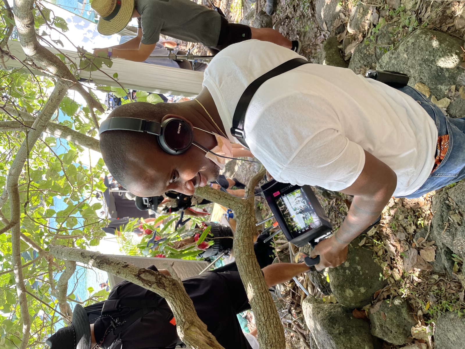 KaMeek on location, monitoring a shot on a film set